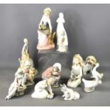 A group of Lladro and other pottery figurines to include Royal Doulton "Thankful" and St Michael