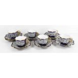 A set of Venetian six coffee cans with seven saucers, the cobalt blue ground with raised lace