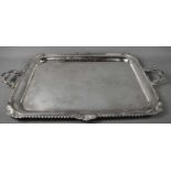 An Asprey of London, solid silver twin handled tray, the deep rim with swirling gadroon and shell