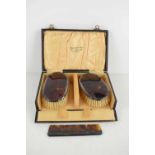 A pair of silver and faux-tortoiseshell gentleman's dressing set, comprising clothes brushes and