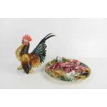 A Karl Ens porcelain model cockerel together with a Portuguese Majolica Palissy style plate modelled