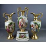 An A.G. Harley Jones of Fenton garniture of two ewers and a twin handled vase on stand, each