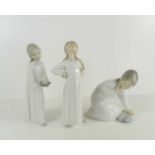 Three Lladro figures of children in nightdresses, one A/F.