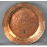 A large Iranian/Middle Eastern silvered copper shallow bowl or charger of sloped circular form, with