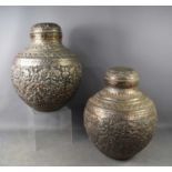 A pair of silvered copper Iranian/Middle Eastern jars and covers, of rotund form with stepped