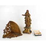 A 19th century Spanish figure of a female saint raised on a decoratively carved base, 33cm high,