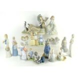 A group of Lladro and other Spanish made figures to include a girl sitting with geese, boy playing