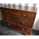 A Georgian III mahogany chest of three graduated drawers with oval brass handles, raised on