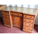 A Victorian mahogany desk, with green tooled leather top, with turned knob, with break front and