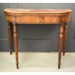 A 19th century mahogany tea table, with folding top, and raised on turned tapered legs, 73cms tall