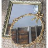 A pair of Victorian style oval mirrors, the gold coloured frames decorated in the rococo style