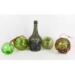 Four antique green glass fishermans balls, and an excavated Benedictine bottle 28cm high.