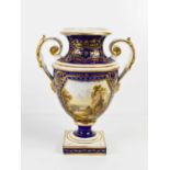 A 19th century Bloor Derby twin handled vase, with a view of Wales, to a blue and gilt ground,