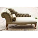 A modern chaise lounge of small proportions with buttoned scroll back raised on short cabriole legs,