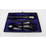An Edwardian silver mounted sewing set with various hallmarks, cased.