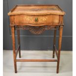 An Edwardian walnut marquetry side table, with serpentine front, single shaped and decoratively