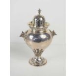 A silver sugar castor, with silver gilt interior, pie crust detail to the top, decorative finial and