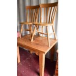 An antique pine kitchen table together with two chairs, table measures 76cms tall by 103cms long