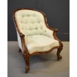 A Victorian rosewood frame armchair, circa 1870, upholstered in silk damask, with scroll carved arms