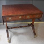 A 19th century mahogany sofa table, with two short drawers and drop leaves, raised on splayed legs