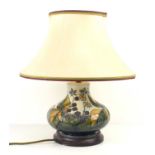 A Moorcroft pottery lamp base of baluster form, raised on a circular plinth.