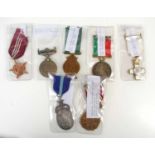 A group of military medals to include a WWII Spain Order of Military Merit medal, Republic of