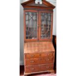 A 19th century mahogany bureau bookcase of small proportions, the split pediment top above two