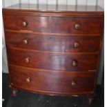 A Victorian mahogany bow fronted chest of two over three graduated drawers, with turned handles,