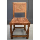 A rare Robert Thompson single chair, with leather strapped seat, octagonal form legs, the back panel