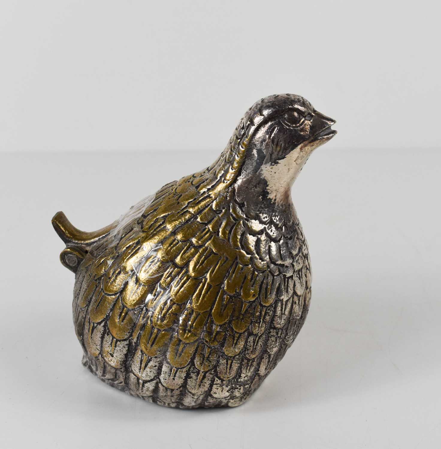 A silver plated novelty ashtray in the form of a quail, with hinged tail, opening to reveal cigar