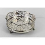 A George III silver wine coaster with pierced and wavy gallery, on ball & claw feet, by