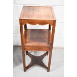 A 19th century mahogany night stand with single drawer shelf and x-form lower tier.