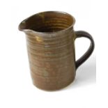 Michael Cardew CBE (1901-1983): a cylindrical, banded jug, with tenmoku glaze, impressed mark to the