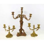 A resin three branch candelabra in the Rocco style together with a pair of gilt metal Louis XV style