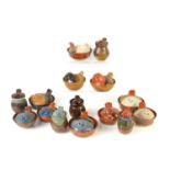 A group of studio art pottery trinket dishes and pots all with bird form lids, various colours and