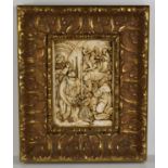 A plaster work relief moulded plaque depicting religious scenes, set in a carved wooden frame,