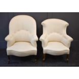 Two antique armchairs, both newly upholstered in cream fabric, raised on short cabriole legs with