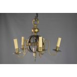 A brass four branch chandelier of central globe construction.