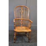 A 19th century Windsor elm armchair, with hoop back, spindle rails, and crinoline stretcher. Appears