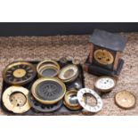 A group of 19th century and later clock parts, including a slate case, enamel dials, convex glass