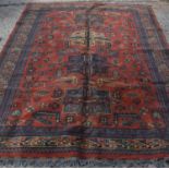 A Tapis D'art Farona Middle Eastern rug with orange ground, depicting animals amidst stylized