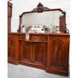 A Victorian mahogany sideboard with mirrored back, two arched panel doors flanking serpentine