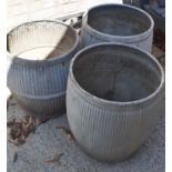 A group of three galvanised metal wash dolly tubs.