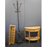 A modern pine demi-lune hall table, metal hall stand and an oak coat rack with eight metal hooks.