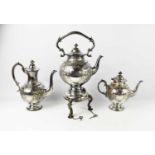 A fine silver plated tea set comprising kettle on stand, tea pot and coffee pot, each engraved