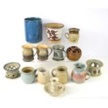 A group of studio pottery to include a "Pretty Ugly" pottery mug, a blue glazed vase signed CW to