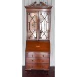 An Edwardian bureau bookcase with glazed upper section, the bureau below having a fitted interior