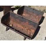 Two cast iron pig troughs, one example made by Johnson Brothers of Spalding. Both troughs have