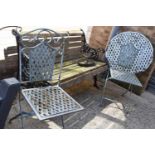 A blue painted wrought iron garden table and chair set together with a garden bench and a cast