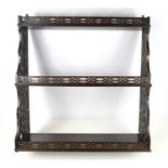 A Chippendale style open fretwork mahogany wall shelf, the fretwork galleries and sides in the
